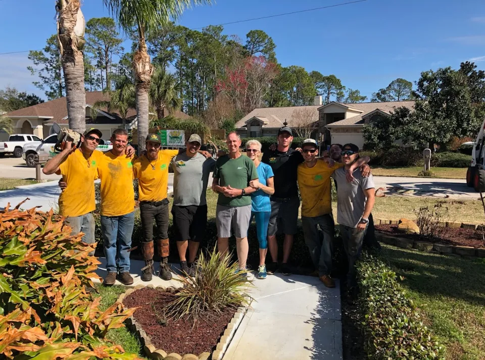 The Tree Kings Florida crew posing with a happy homeowner after a completed job